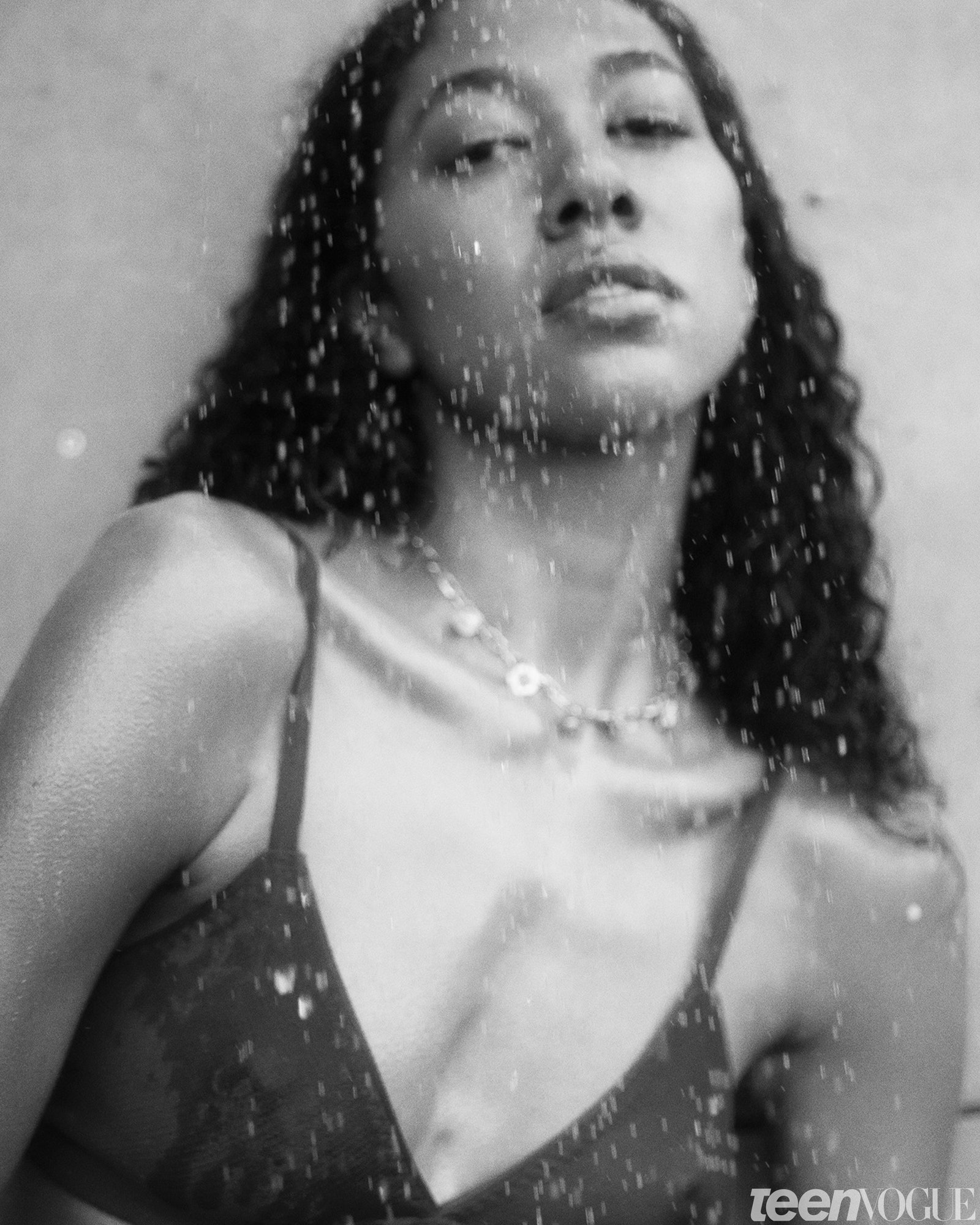 Aoki Lee Simmons standing underneath a shower head.